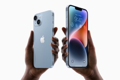 Two hands hold up iPhone 14 and iPhone 14 Plus.  
