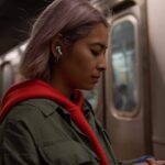 An AirPods Pro user waiting for a train.