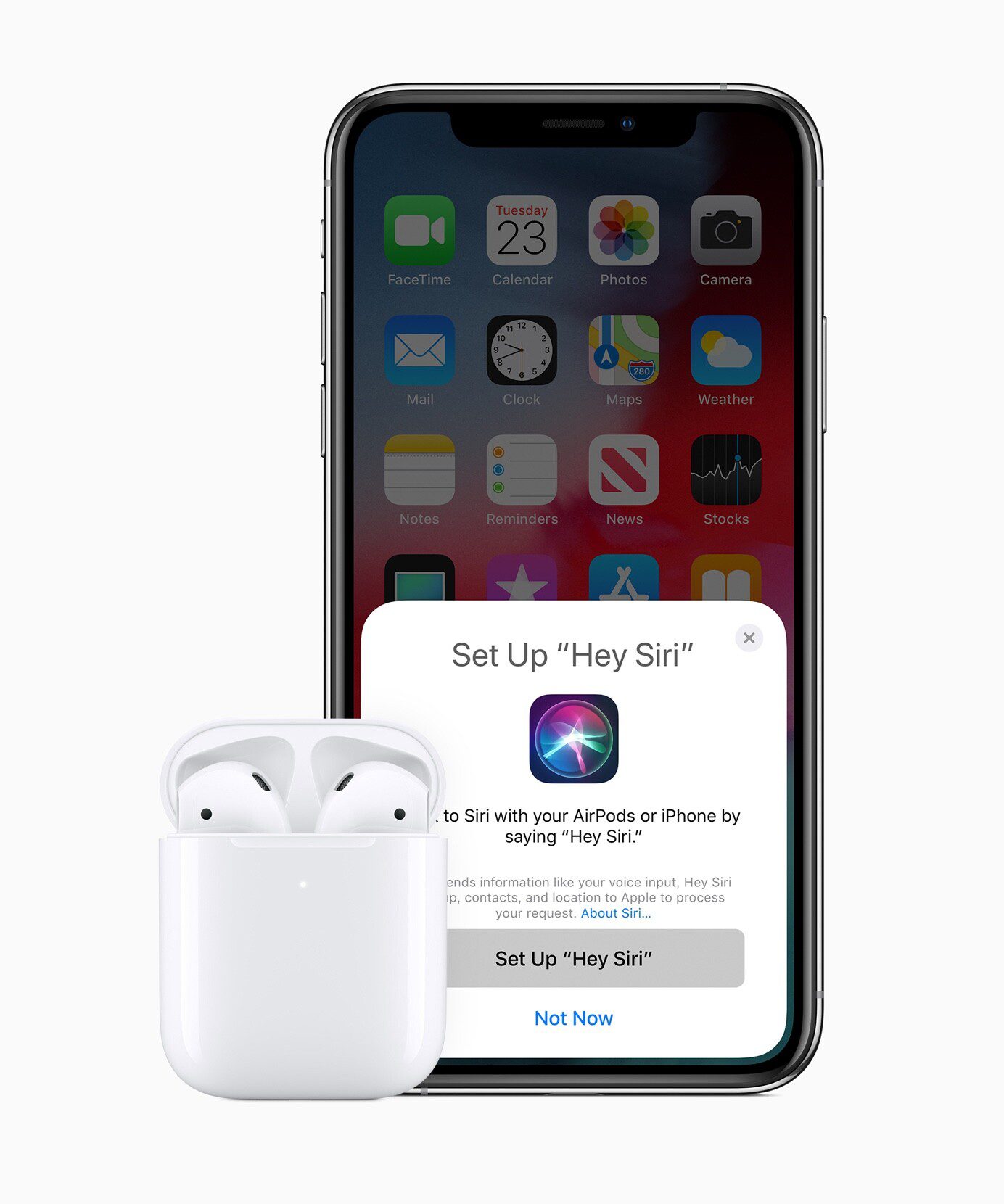 AirPods in case next to iPhone.  