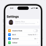 An iPhone showing the owner's name greyed out at the top of Settings.  