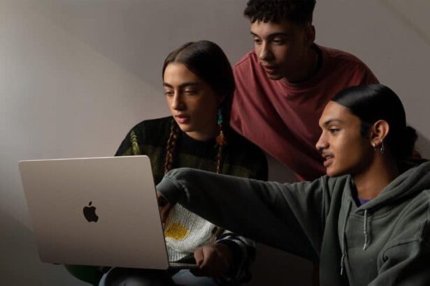 Three people looking at the 15-inch MacBook Air.