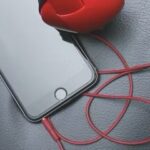 Phone with headphones plugged into jack