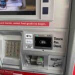 A photo of gas station pump with Apple Pay logo  