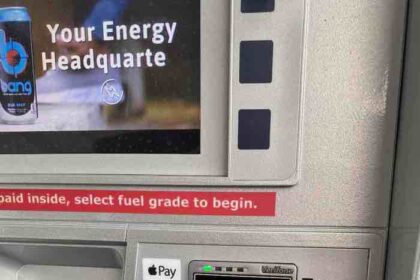A photo of gas station pump with Apple Pay logo  
