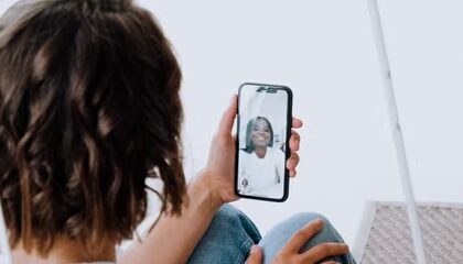person holding iphone and engaged in video call  