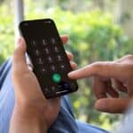 A man using the dialer on his iPhone  