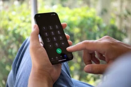 A man using the dialer on his iPhone  