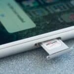 Verizon SIM card being removed from an Apple iPhone