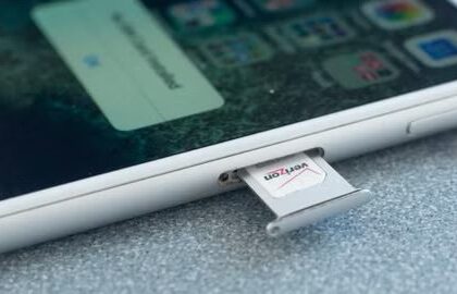 Verizon SIM card being removed from an Apple iPhone