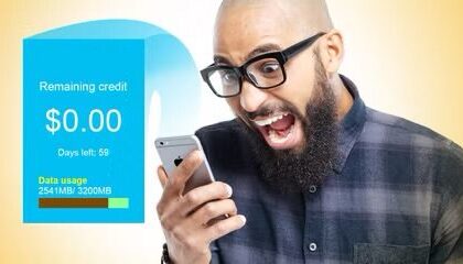 Man looking shocked at his iPhone, which has run out of remaining credit.