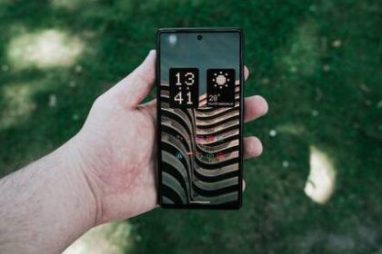 A hand holding an Android smartphone