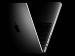 The new 14-inch MacBook Pro shown propped open and angled to the side.
