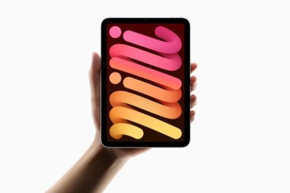 A hand holds up the new iPad mini.