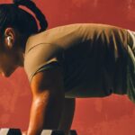 An image of a user wearing AirPods Pro 3 during a workout.