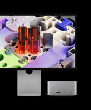 Mac Studio paired with Studio Display XDR, device tucked under screen: Studio Display XDR has a three-dimensional puzzle-like wallpaper