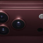 iPhone 18 Pro, burgundy finish, partial back exterior angled to show pro camera system in top left corner, 3 lenses, microphone, flash