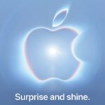 Apple graphic showing its logo with a bright light at the center on a blue-gray background. text: Surprise and shine
