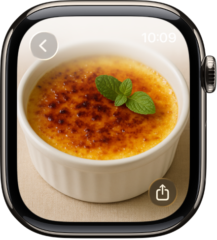 While viewing a photo, turn the Digital Crown to zoom, drag to pan, or double-tap to switch between viewing all of the photo and filling the screen. Swipe left or right to see the next photo. A Share button is on the bottom right.