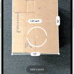 A screen showing the measurement of the dimensions of a box in the Measure app. The area of the box is calculated from the measurements of the dimensions.
