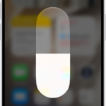 The iPhone Home Screen with Dark Mode on.