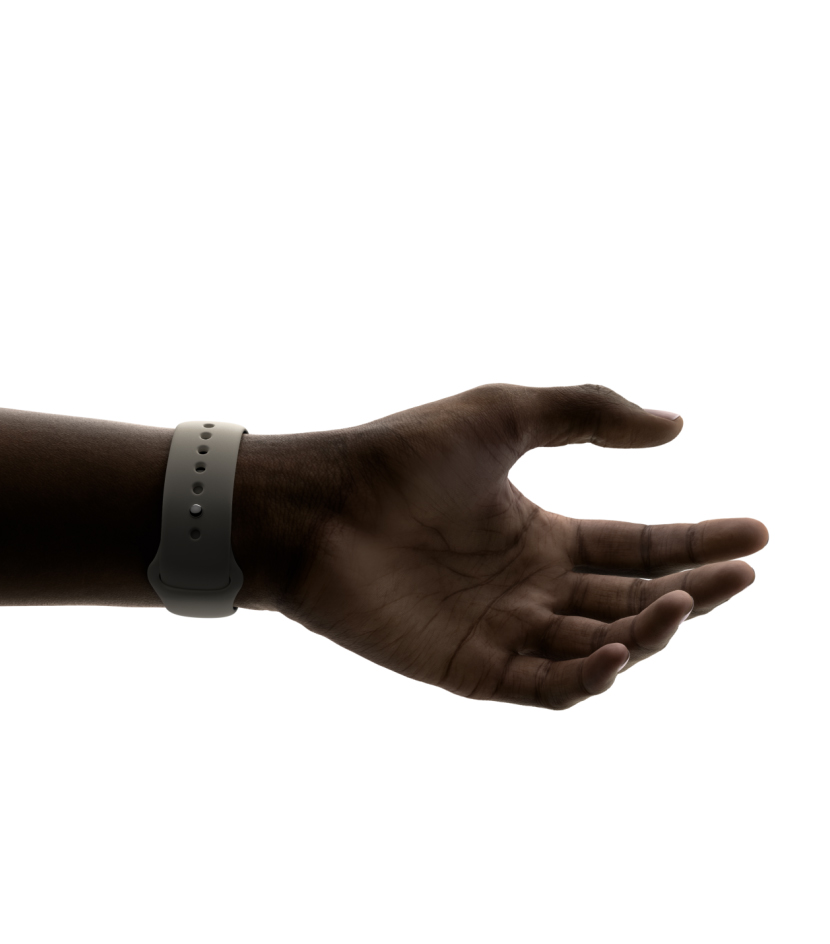 A hand wearing Apple Watch, with the thumb and index finger ready to make the double tap gesture.