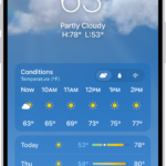 The Weather app showing, from top to bottom: the location, current temperature, the high and low temperatures for the day, hourly forecast, and the first few days of a 10-day forecast. A row of dots at the bottom center represent other locations in the location list. At the bottom-right corner is the Location List button and at the bottom-left corner is the Show Map button.