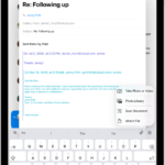 A draft email being composed with the attachment options above the keyboard.