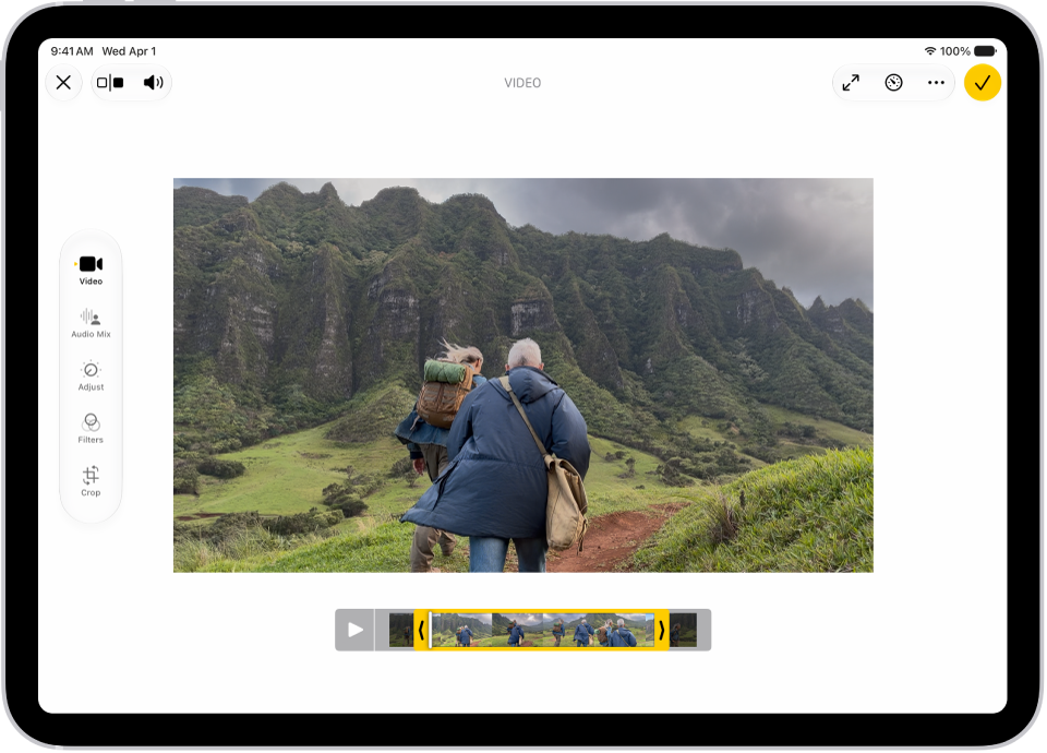 The Edit screen in the Photos app with a video playing in the center. The video's frame viewer is across the bottom of the video and a yellow outline is around the selected frames to include in the trimmed video. On the left side of the screen are the Video, Adjust, Filters, and Crop buttons; the Video button is selected.