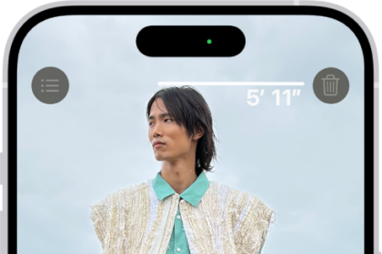 A person's height being measured in the Measure app, with the height measurement showing at the top of the person's head. The Take Picture button is near the lower-right corner for taking a picture of the measurement. The green Camera In Use indicator appears at the top.