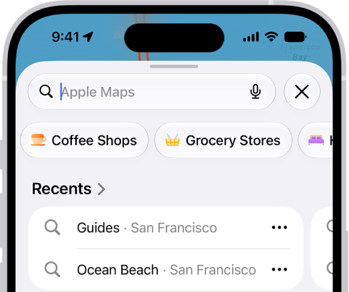 The Maps app showing the search field, categories for nearby services, and city guides. In the bottom part of the screen is the iPhone onscreen keyboard.