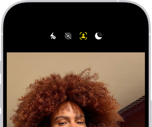 The Camera screen in Photo mode. Within the camera frame, the subjects are taking a selfie.
