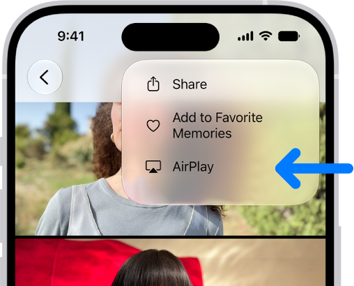 A slideshow in the Photos app plays on the iPhone. At the top right of the screen is a pop-up menu, with an option to choose AirPlay.