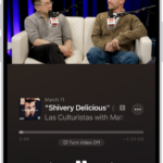 The Now Playing screen in the Podcasts app, showing a video. Below the video is the podcast artwork, the episode title, the playback controls, and the volume slider. At the bottom of the tab are the View Transcript button, the AirPlay icon, and the Playing Next button.